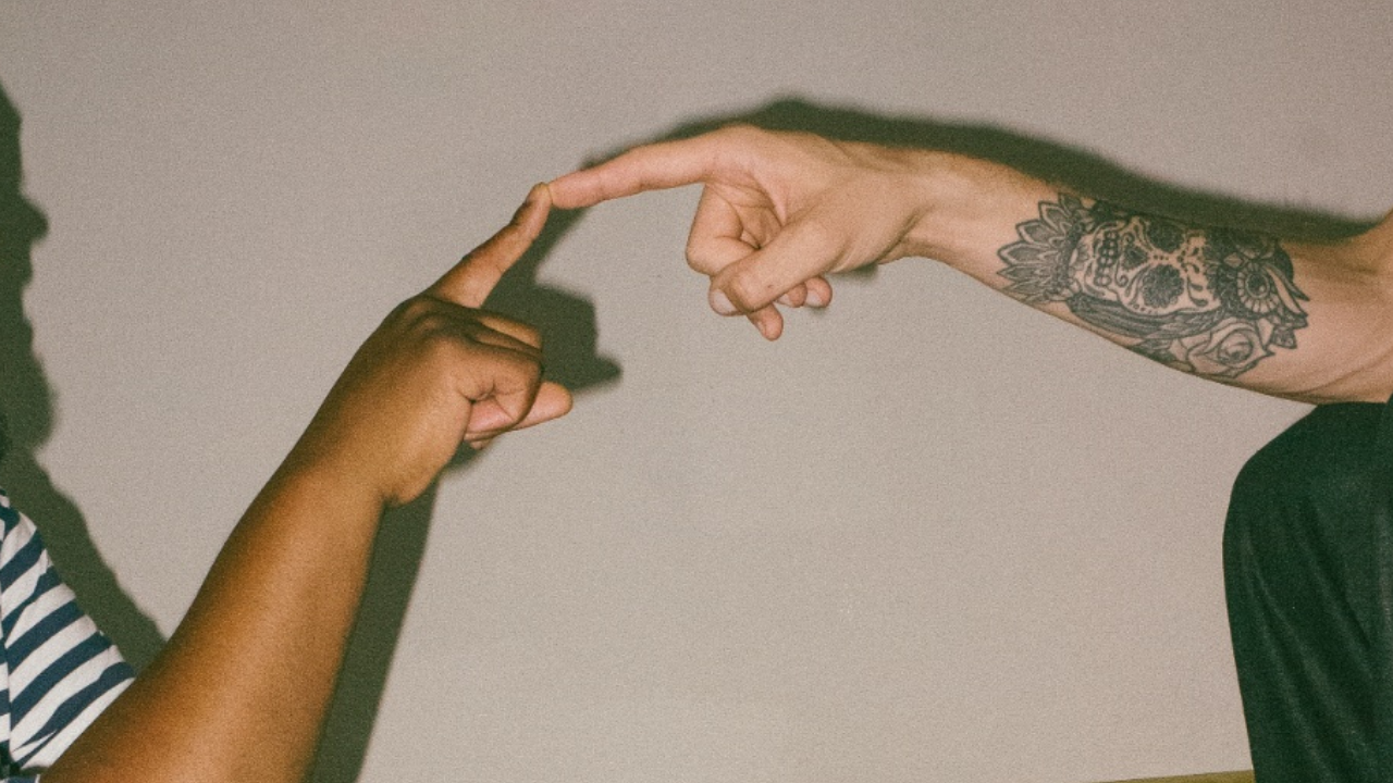 Two hands reaching toward each other